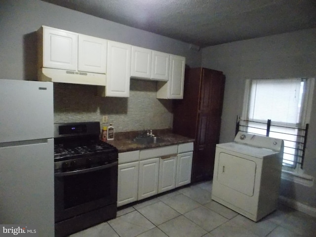 716 N Milton Ave, Baltimore, MD 21205 - kitchen featuring freestanding refrigerator, black range with gas cooktop, washer / clothes dryer, under cabinet range hood, and backsplash