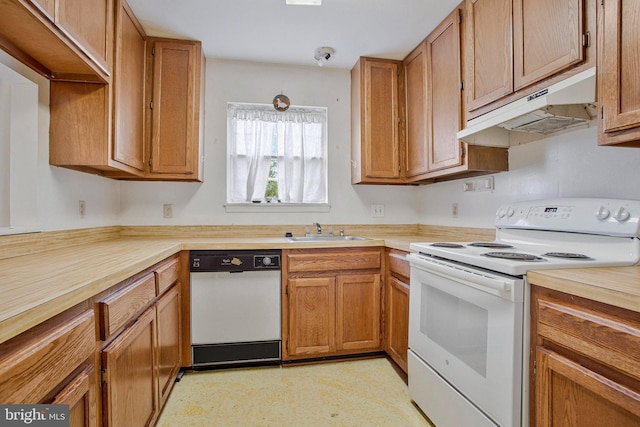 10734 Castleton Way, Upper Marlboro, MD 20774 - kitchen with white appliances, under cabinet range hood, a sink, and brown cabinetry
