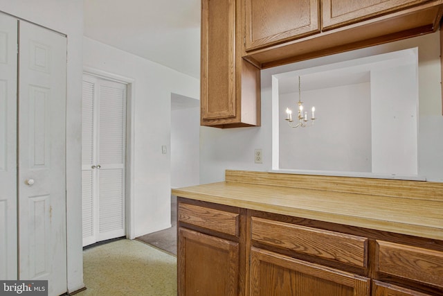 10734 Castleton Way, Upper Marlboro, MD 20774 - kitchen with a chandelier and brown cabinets