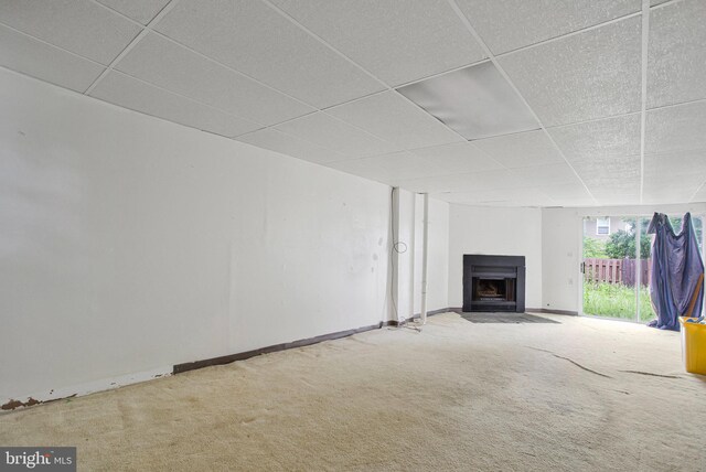 10734 Castleton Way, Upper Marlboro, MD 20774 - unfurnished living room featuring a drop ceiling, a fireplace with flush hearth, carpet, and baseboards
