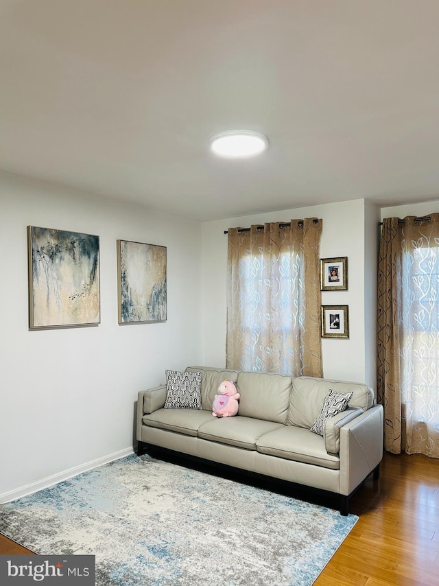 living area featuring wood finished floors and baseboards