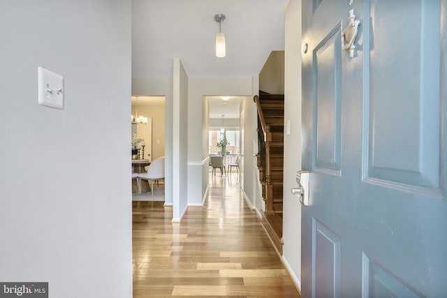 9807 Spillway Ct, Burke, VA 22015 - entrance foyer featuring wood finished floors, baseboards, a chandelier, and stairs