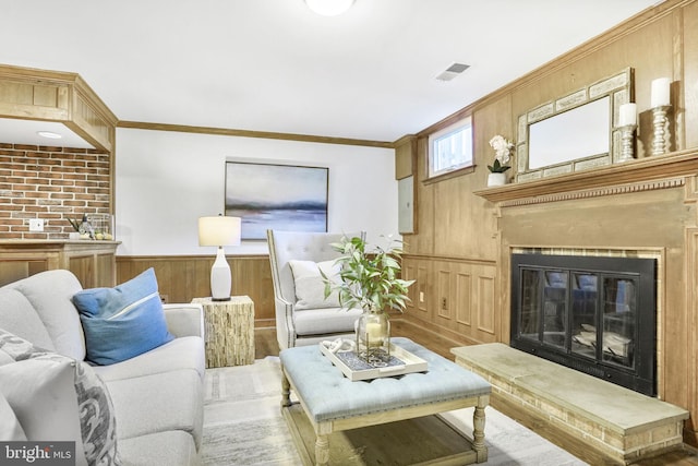 9807 Spillway Ct, Burke, VA 22015 - living room featuring a wainscoted wall, ornamental molding, wood finished floors, a glass covered fireplace, and wooden walls