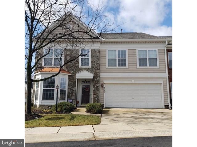 8790 Sage Brush Way Unit 19, Columbia, MD 21045 - view of front of property featuring an attached garage, driveway, and stone siding
