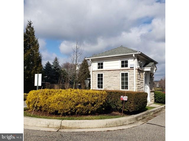 8790 Sage Brush Way Unit 19, Columbia, MD 21045 - view of home's exterior featuring stone siding and a shingled roof