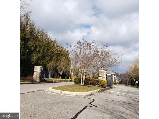 8790 Sage Brush Way Unit 19, Columbia, MD 21045 - view of asphalt road with curbs and a gate
