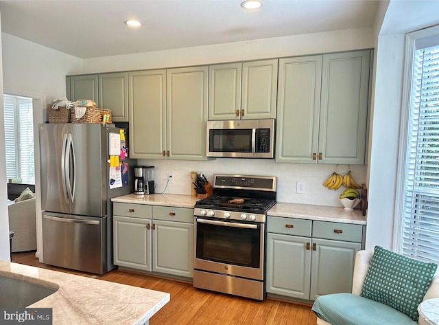 45 Arell Ct, Alexandria, VA 22304 - kitchen featuring stainless steel appliances, light countertops, backsplash, gray cabinetry, and recessed lighting