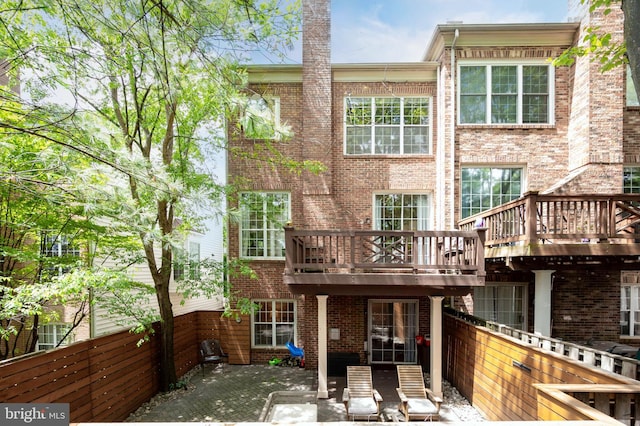 45 Arell Ct, Alexandria, VA 22304 - rear view of house featuring brick siding, a patio area, and a wooden deck