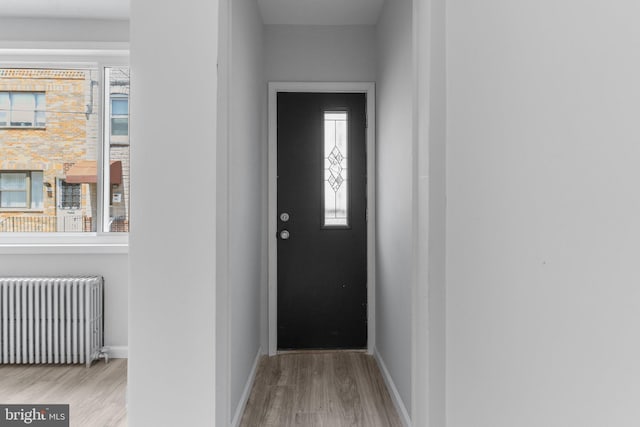 1906 Durfor St, Philadelphia, PA 19145 - doorway featuring radiator heating unit, wood finished floors, and baseboards