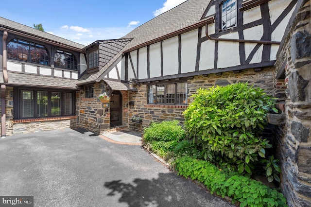 410 Arthurs Round Table, Wynnewood, PA 19096 - property entrance featuring stone siding and a shingled roof