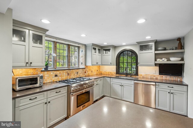 410 Arthurs Round Table, Wynnewood, PA 19096 - kitchen featuring stainless steel appliances, open shelves, dark countertops, a sink, and backsplash