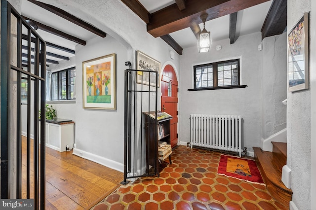 410 Arthurs Round Table, Wynnewood, PA 19096 - entryway with radiator heating unit, beam ceiling, arched walkways, baseboards, and a textured wall