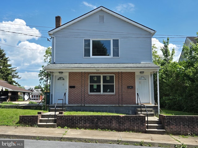 313 Park St, Waynesboro, PA 17268 - view of front of property with brick siding, a chimney, and a porch
