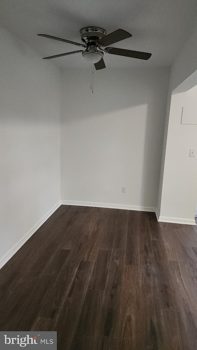 313 Park St, Waynesboro, PA 17268 - spare room featuring a ceiling fan, dark wood-style flooring, and baseboards