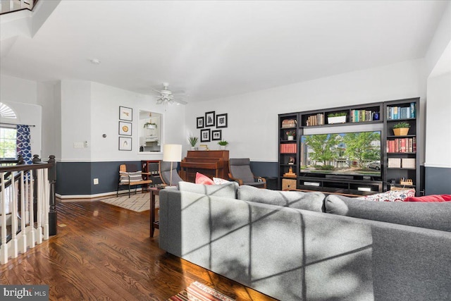 living area with ceiling fan, wood finished floors, and baseboards