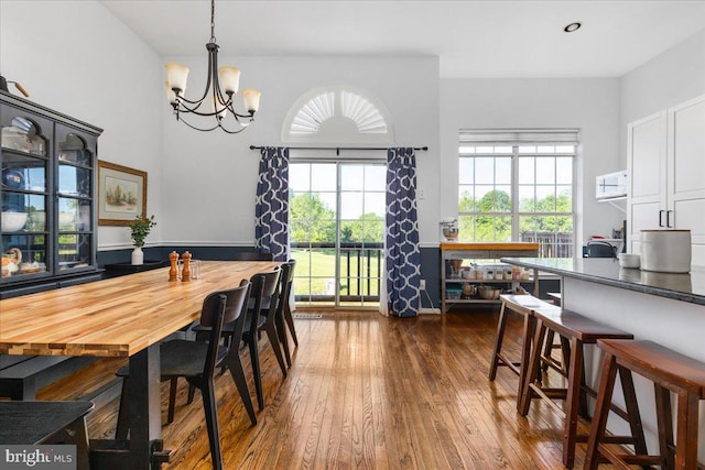 dining space with a chandelier and dark wood finished floors