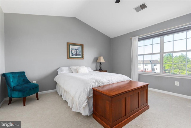 bedroom featuring light colored carpet, baseboards, lofted ceiling, and ceiling fan