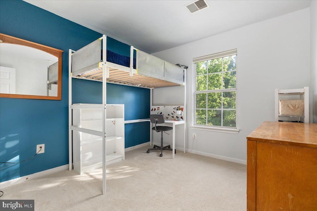 bedroom featuring an office area, baseboards, and carpet flooring