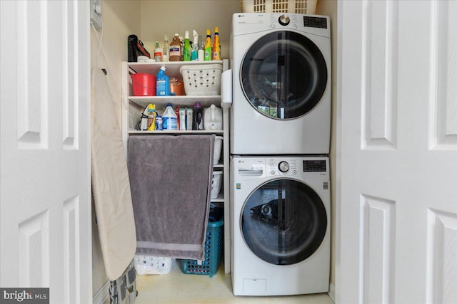 clothes washing area with stacked washing machine and dryer