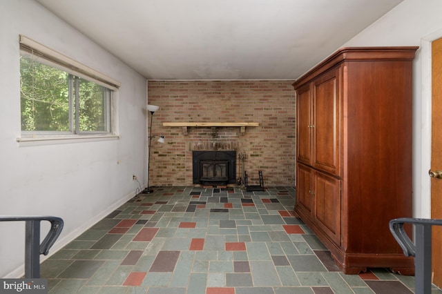 unfurnished living room with baseboards