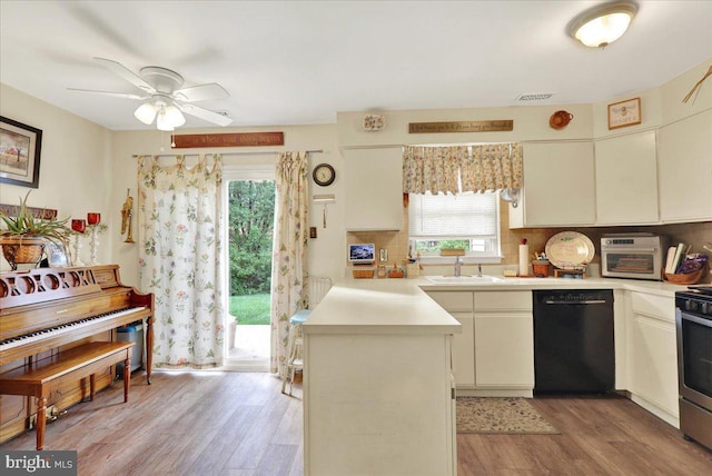 kitchen with dishwasher, a sink, light wood-type flooring, and light countertops