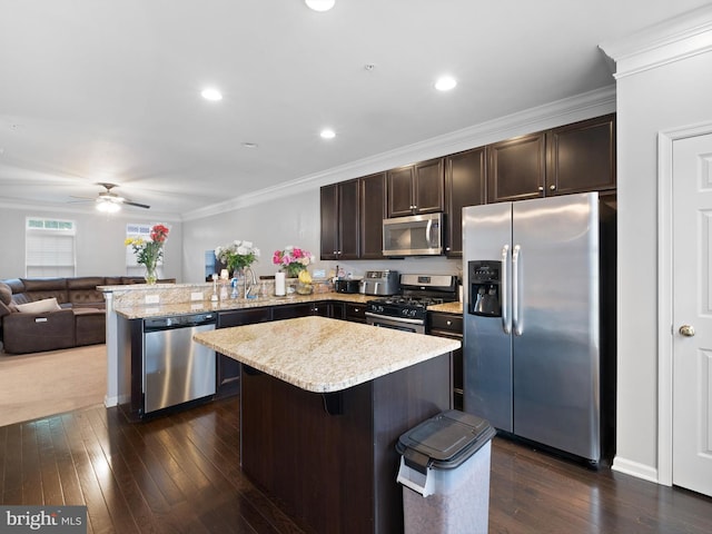 1390 Parish Ave, Claymont, DE 19703 - kitchen with appliances with stainless steel finishes, dark brown cabinetry, a peninsula, open floor plan, and a ceiling fan