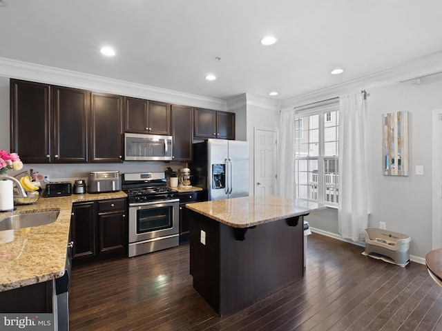 1390 Parish Ave, Claymont, DE 19703 - kitchen with stainless steel appliances, a sink, a kitchen island, dark brown cabinetry, and light stone counters