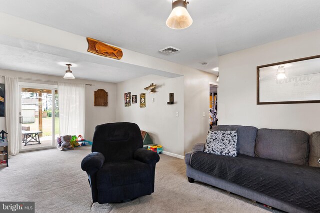 carpeted living area featuring baseboards