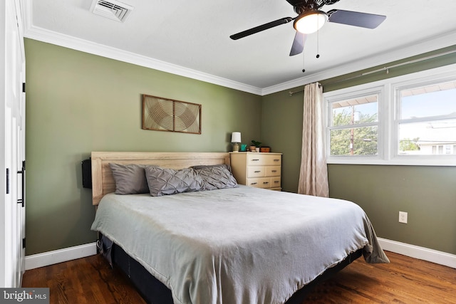 bedroom with baseboards, ornamental molding, wood finished floors, and ceiling fan