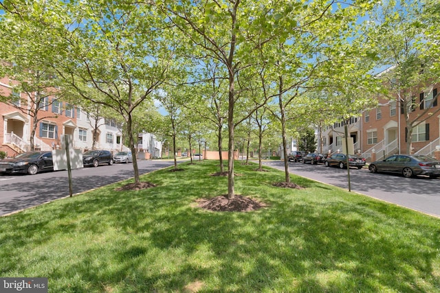 surrounding community with a residential view and a lawn