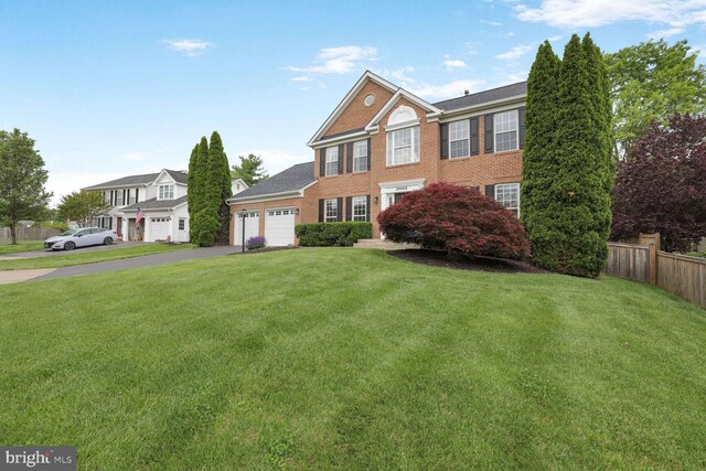 view of front of property featuring an attached garage, driveway, and brick siding