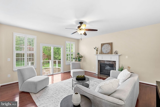 43127 Rocks Way, Leesburg, VA 20176 - living room with a high end fireplace, ceiling fan, wood finished floors, and baseboards