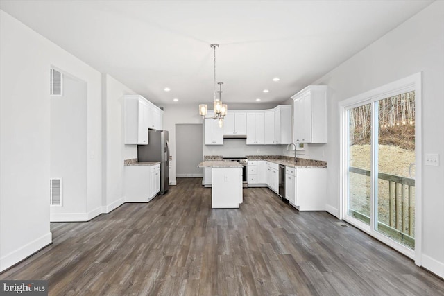 6741 Ginseng Ln, King George, VA 22485 - kitchen featuring appliances with stainless steel finishes, a chandelier, a sink, baseboards, and dark wood finished floors