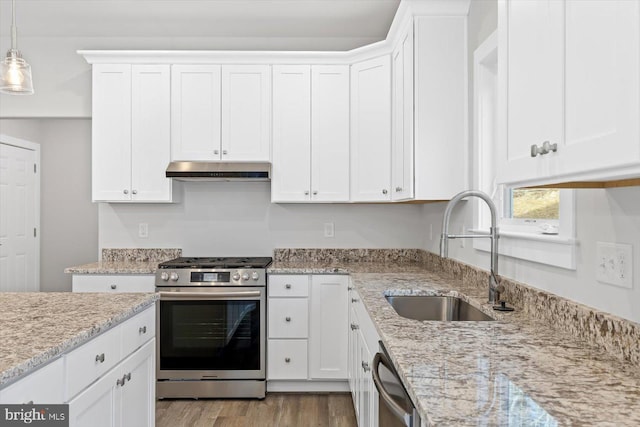 6741 Ginseng Ln, King George, VA 22485 - kitchen with stainless steel appliances, a sink, under cabinet range hood, and white cabinetry