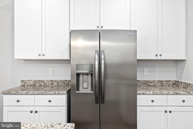 6741 Ginseng Ln, King George, VA 22485 - kitchen featuring stainless steel fridge with ice dispenser, white cabinetry, and light stone counters