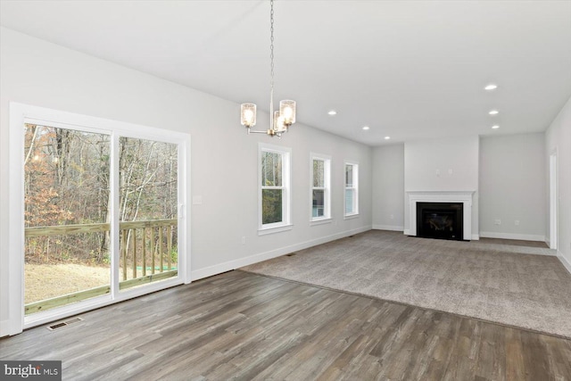 6741 Ginseng Ln, King George, VA 22485 - unfurnished living room featuring wood finished floors, a chandelier, baseboards, recessed lighting, and a fireplace