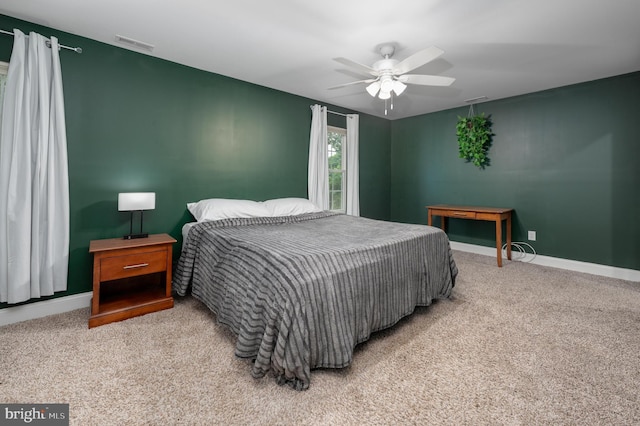 carpeted bedroom featuring baseboards and ceiling fan