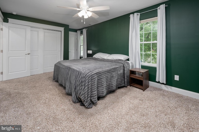 carpeted bedroom featuring a ceiling fan and baseboards