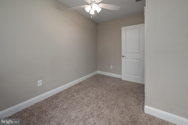 carpeted empty room with ceiling fan and baseboards