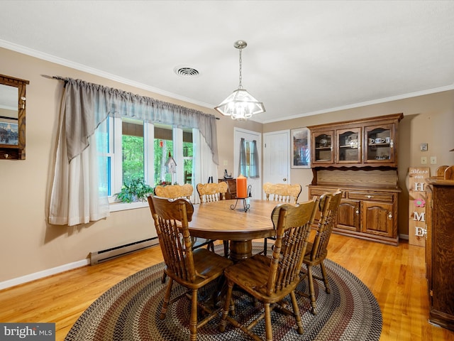 dining room featuring a chandelier, light wood-style floors, ornamental molding, a baseboard radiator, and baseboards