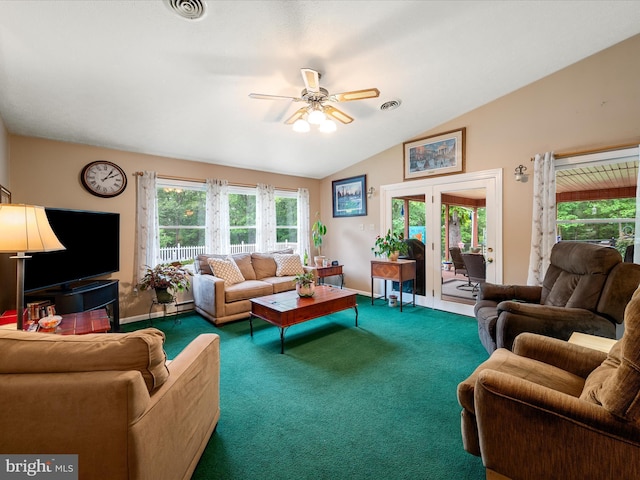 living room featuring healthy amount of natural light, a ceiling fan, carpet floors, lofted ceiling, and baseboards