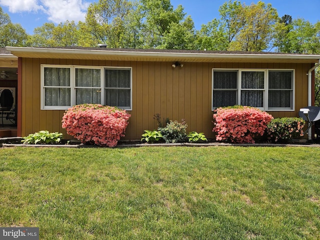 view of side of property with a yard