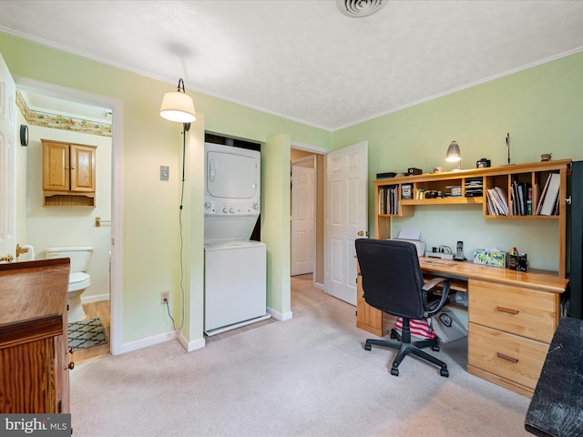 office with stacked washer / drying machine, light colored carpet, ornamental molding, and baseboards