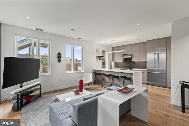 1932 9th St NW Unit R402, Washington, DC 20001 - living area with plenty of natural light, light wood-style flooring, baseboards, and recessed lighting