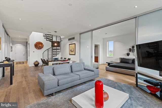 1932 9th St NW Unit R402, Washington, DC 20001 - living area featuring light wood finished floors, arched walkways, and recessed lighting