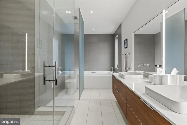 1932 9th St NW Unit R402, Washington, DC 20001 - full bath featuring tile patterned flooring, a shower stall, a tub, double vanity, and toilet