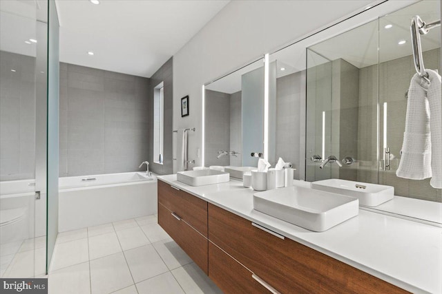 1932 9th St NW Unit R402, Washington, DC 20001 - full bath with double vanity, tile patterned flooring, a stall shower, and a garden tub