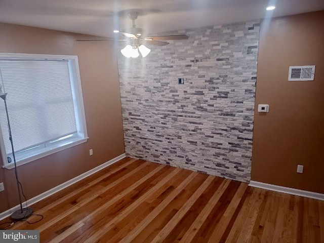 unfurnished dining area with ceiling fan, wood finished floors, baseboards, and recessed lighting