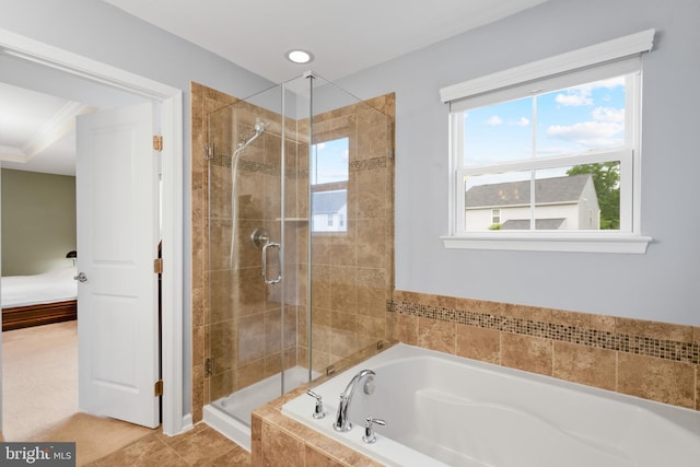 ensuite bathroom featuring a shower stall and a bath