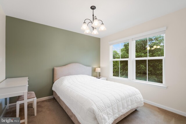 bedroom featuring carpet flooring, baseboards, and a chandelier